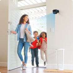 GuardHouse camera shown at a door frame. Lifestyle product photograph.